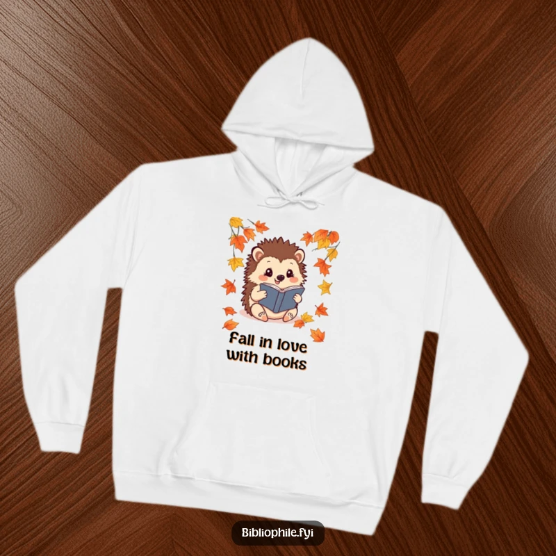 Funny Hedgehog Hoodie: A cheerful hedgehog reads a book surrounded by fallen leaves, designed for cozy autumn days.