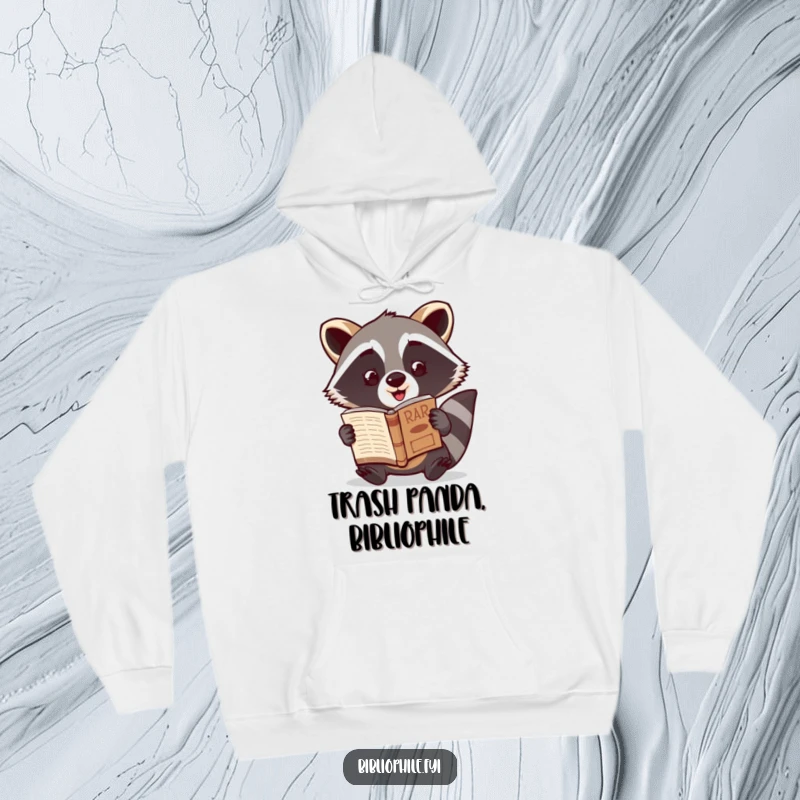 Funny Raccoon Hoodie showing a cute raccoon character excitedly showcasing a newly discovered rare book, offering warm comfort and humorous discovery.