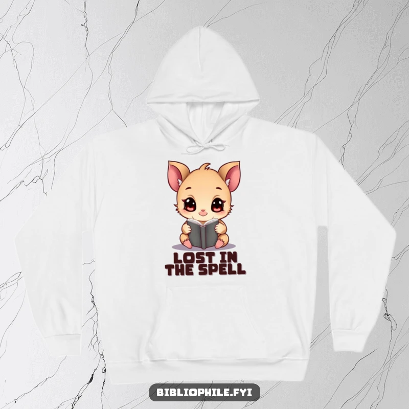 Funny tiny creature engrossed in a magical tome, depicted on a cozy, warm hoodie.