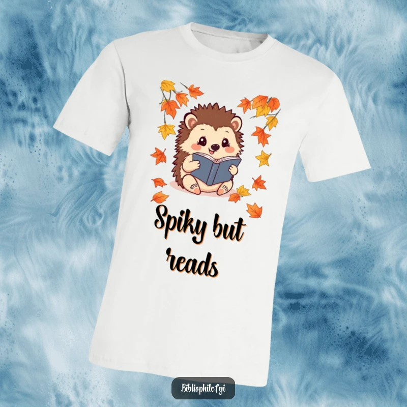 Funny Hedgehog T-Shirt: A cheerful hedgehog reads a book surrounded by fallen leaves, showcasing cozy autumn reading.